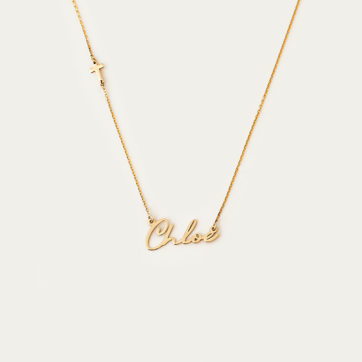 Individual name necklace with side cross in 585 gold